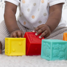 Plastic cube blocks in yellow, red, teal, and more with tactile embossed sides