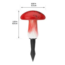 Red mushroom solar light with domed cap, white glow, and black stake