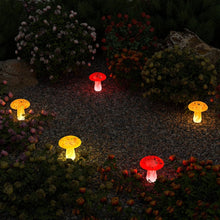 Solar mushroom landscape light with red cap, glowing white stem and black stake