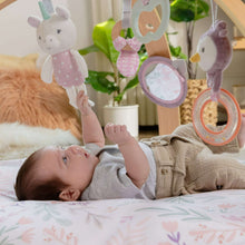 Baby activity gym play mat with hanging toys displayed above a sleeping baby on the cushion