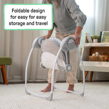 Foldable portable baby swing standing upright with protective handles