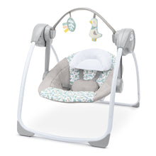 Portable baby swing with gray frame and plush cushioned seat, blue leaf pattern