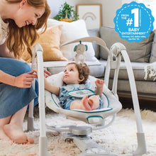 Gray portable vibrating baby swing with plush overhead toy and infant seat