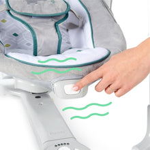 Gray baby swing control panel with teal-trim seat pad and padded infant bouncer