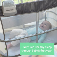 Gray baby bassinet with breathable mesh sides and ingenuity control pad on top rail