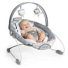 Infant reclining in gray and white automatic baby bouncer with hanging toys