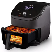 Black 6-in-1 air fryer with digital display and open basket showing food