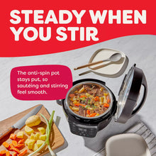 Instant Pot RIO Mini 4-qt multi-cooker, open pot with two utensils on side