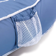 Inflatable lounge chair side pocket with white mesh panel on blue fabric