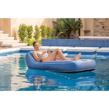Inflatable lounge chair with blue frame and white striped top for poolside