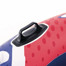 Inflatable river float with black handle on red-and-blue dotted fabric