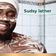 White foaming body wash covering face and shoulders during a shower