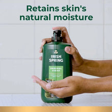 Green body wash bottle with pump, hands holding it in a shower