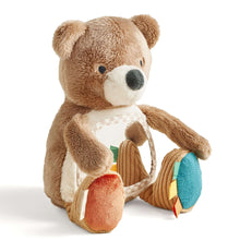 Plush bear sensory toy with white mirror panel and colorful fabric tags