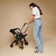 Stroller with farm spiral activity toy attached, featuring plush animals and soft hanging parts
