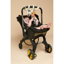 Farm spiral car seat toy clipped to a stroller, with plush arches and character parts