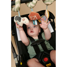 Baby holding a farm spiral toy with soft plush animals and ring link attachments