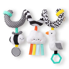 Spiral stroller toy with black-and-white plush animals and a teal teether ring