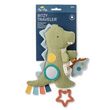 Itzy Ritzy Bitzy traveler dino toy on retail card with teal ring and star clip