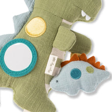 Olive green fabric dino toy with yellow circle, teal ring, and small blue dino detail