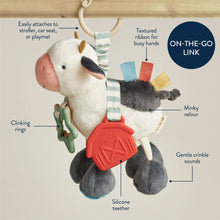 Plush cow activity toy with silicone teether, textured rubber links, and fabric tags