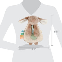 Taupe plush bunny lovey hanging with ribbon crinkle strap and mint heart bib