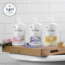 Assorted Ivory gentle body wash bottles with different label designs on a tray