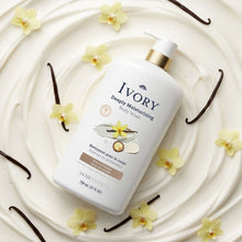 Ivory body wash bottle with gold pump on creamy surface with flower accents