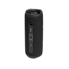 Black JBL Flip 6 speaker with control buttons and port panel on the side.