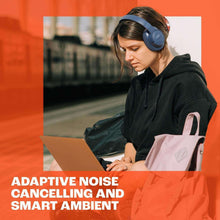 Over-ear wireless headphones worn by person with dark hoodie and blue shirt