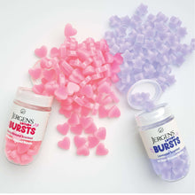 Set of Jergens Lotion Bursts jars with pink and lavender heart-shaped pieces