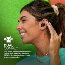 Black true wireless earbuds in use on a woman, earbuds seated in ears