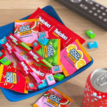 Assorted Jolly Rancher and Twizzlers fruit candy packs in blue tray
