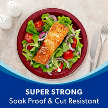 10-inch red paper dinner plate with salad greens and salmon on top
