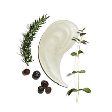Thick white cleansing gel swatch with herb sprigs and juniper berries