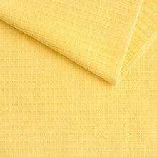 Light yellow kitchen towel with subtle woven jacquard texture and fine pattern