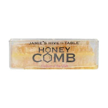 Honeycomb honey loaf in clear plastic container with amber-gold grid texture
