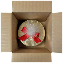 Chocolate bark duo tin inside open cardboard box with red bow