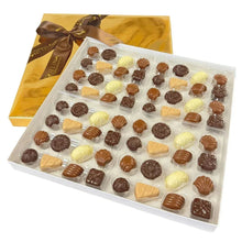 Handcrafted chocolate gift box with assorted chocolates in clear tray and brown-gold ribbon