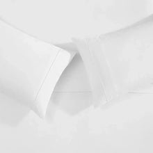 White pillowcase and sheet corner with stitched edge