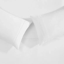 White pillowcases and fitted sheet corners with clean stitched seams