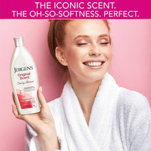 Jergens Original Scent cherry almond body lotion bottle held with a towel