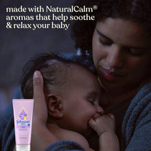 Johnson's baby bedtime cream tube next to sleeping baby in parent cuddle