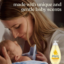 Johnson's baby wash & shampoo with pump bottle beside mother holding sleeping baby