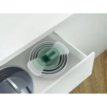 Nested green measuring bowls in a white tray-style organizer
