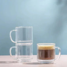 Set of fluted double-wall glass mugs, clear and amber styles, stacked side view