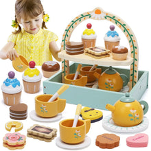 Wooden pretend tea set with yellow teapot, cups, plates, and a cupcake stand