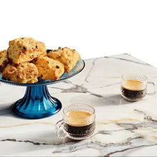 Clear 3 oz espresso cup with textured glass sides and handle, two cups shown