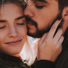 Man and woman cuddling, man's beard and mustache visible