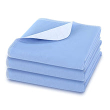 Light blue washable bed pads, folded stack of 3 absorbent waterproof pads